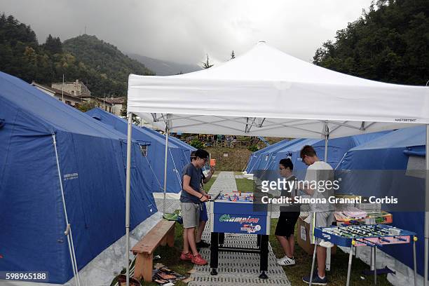 Children play table football in the tent camp erected for earthquake victims on August 31, 2016 in Arquata del Tronto, Italy. The region was struck...