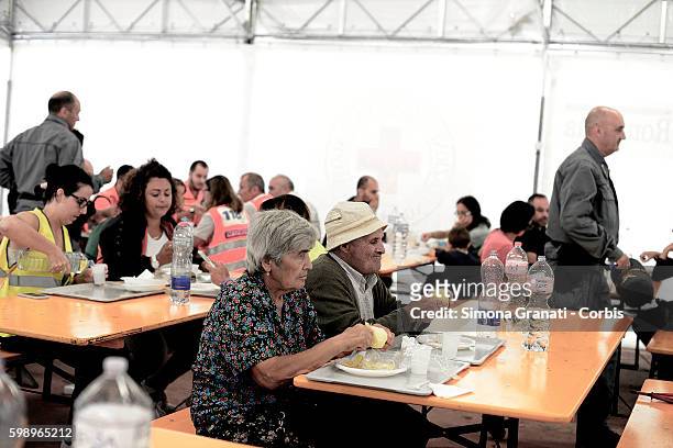 An elderly couple eat in the canteen area of the tent camp erected for earthquake victims on August 31, 2016 in Arquata del Tronto, Italy. The region...
