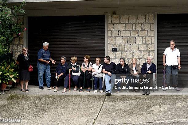 Residents sit near the tent camp erected for earthquake victims on August 31, 2016 in Arquata del Tronto, Italy. The region was struck by a powerful,...