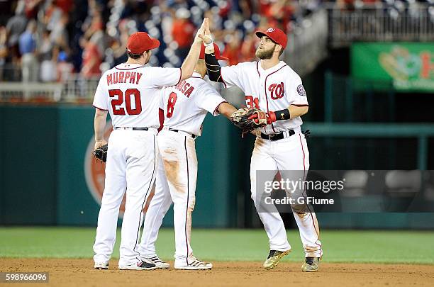 Bryce Harper of the Washington Nationals celebrates with Daniel Murphy after a victory against the Colorado Rockies at Nationals Park on August 26,...