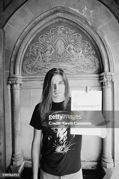 American singer and songwriter Evan Dando, of The Lemonheads, poses with the words 'Permanent Damage' written on hotel notepaper at the Chateau...