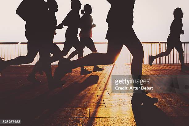 people running in barcelona boardwalk on sunrise. - intensidade de cores imagens e fotografias de stock