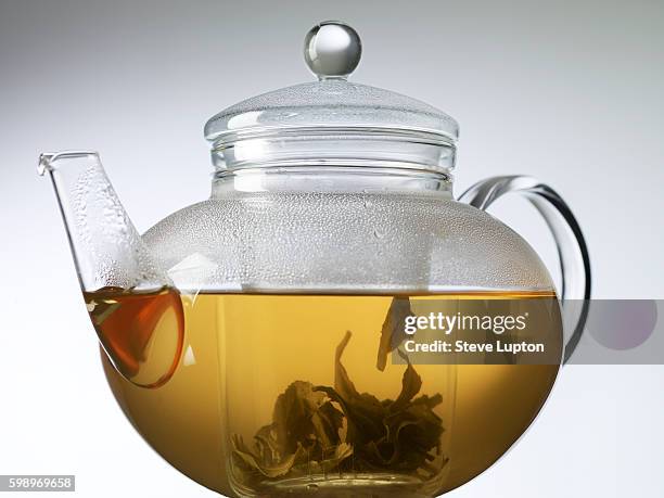 infusing gunpowder tea in a glass teapot - teapot stock pictures, royalty-free photos & images