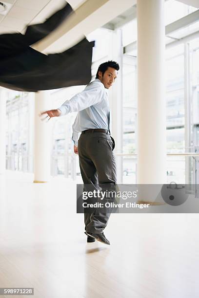 businessman throwing suit blazer - oliver eltinger stock-fotos und bilder