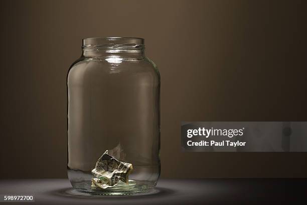 money in a glass jar - mason jar stock pictures, royalty-free photos & images