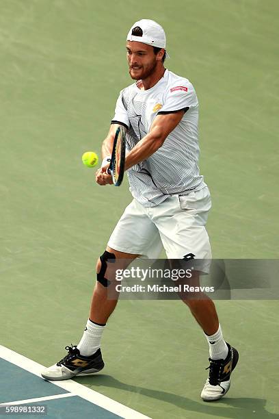 Joao Sousa of Portugal returns a shot to Grigor Dimitrov of Bulgaria during his third round Men's Singles match on Day Six of the 2016 US Open at the...