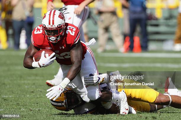 Dare Ogunbowale of the Wisconsin Badgers is tackled by Duke Riley of the LSU Tigers during the first half at Lambeau Field on September 3, 2016 in...