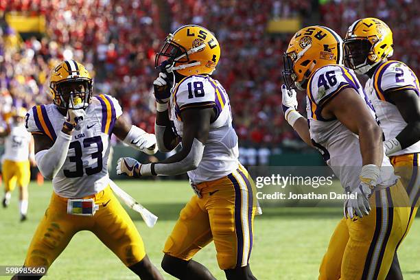 Tre'Davious White of the LSU Tigers celebrates with teammates after returning an interception for a touchdown during the third quarter against the...