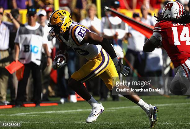 Travin Dural of the LSU Tigers runs with the ball on his way to scoring a touchdown after making a 10-yard reception against the Wisconsin Badgers...
