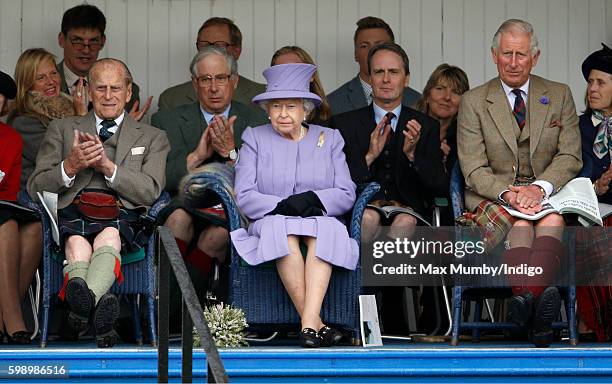 Prince Philip, Duke of Edinburgh, Queen Elizabeth II and Prince Charles, Prince of Wales attend the 2016 Braemar Highland Gathering at The Princess...