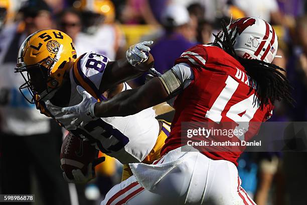 Travin Dural of the LSU Tigers runs with the ball against D'Cota Dixon of the Wisconsin Badgers on his way to scoring a touchdown after making a...