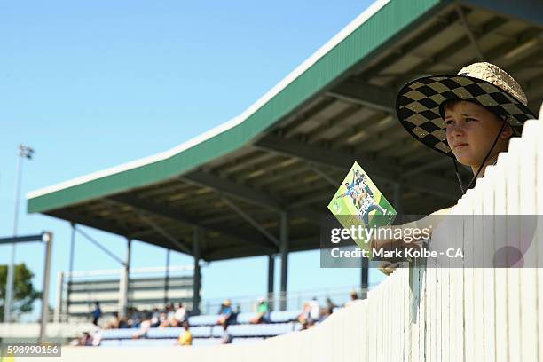 Young cricket fan watches on from the boundary during the Cricket Australia via Getty Images Winter Series Final match between India A and Australia...