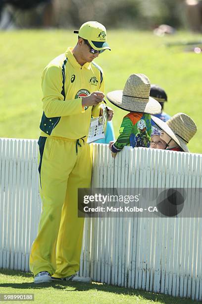 Nic Maddinson of Australia A signs autographes for young supporters on the boundary during the Cricket Australia via Getty Images Winter Series Final...