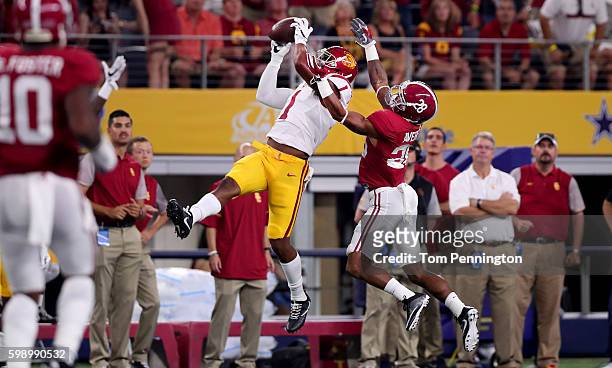 Darreus Rogers of the USC Trojans catches a pass against Anthony Averett of the Alabama Crimson Tide in the first quarter during the AdvoCare Classic...
