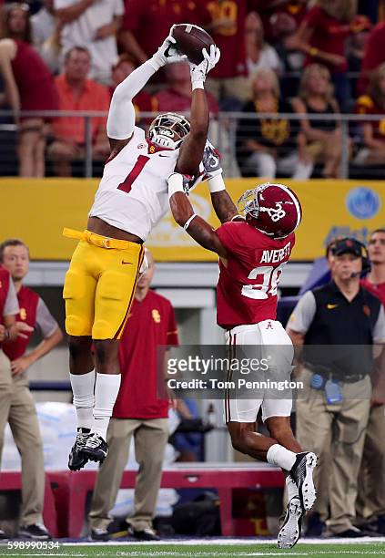 Darreus Rogers of the USC Trojans catches a pass against Anthony Averett of the Alabama Crimson Tide in the first quarter during the AdvoCare Classic...