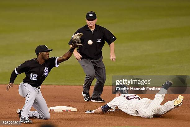 Max Kepler of the Minnesota Twins slides safely into second base with a double as Tim Anderson of the Chicago White Sox fields the ball and umpire...