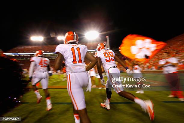 Chris Register, Shadell Bell and Clelin Ferrell of the Clemson Tigers run onto the field prior to the game against the Auburn Tigers at Jordan Hare...