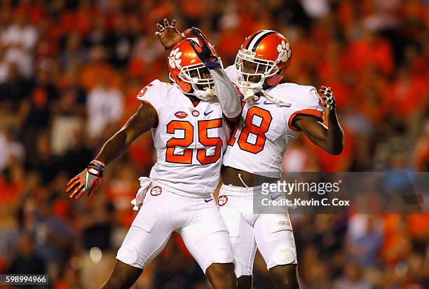 Jadar Johnson celebrates with Cordrea Tankersley of the Clemson Tigers after intercepting a pass during the second half against the Auburn Tigers at...