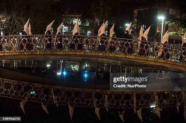 Nazarenes in the procession of prayer crossing a bridge in the gardens of Pereda de Santander SANTANDER, Spain on March 21, 2016. Santander Easter...