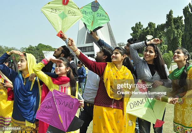 Girls dressed in yellow take part in Kite flying on the occasion of Basant Panchami Festival at Punjabi University. Basant Panchami is a Hindu...