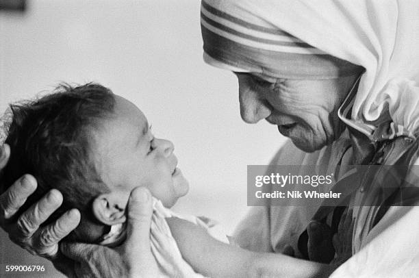 Mother Teresa with a child from the orphanage she operates in Calcutta, India, 1st May 1974. Mother Teresa , the Roman Catholic-Albanian nun revered...