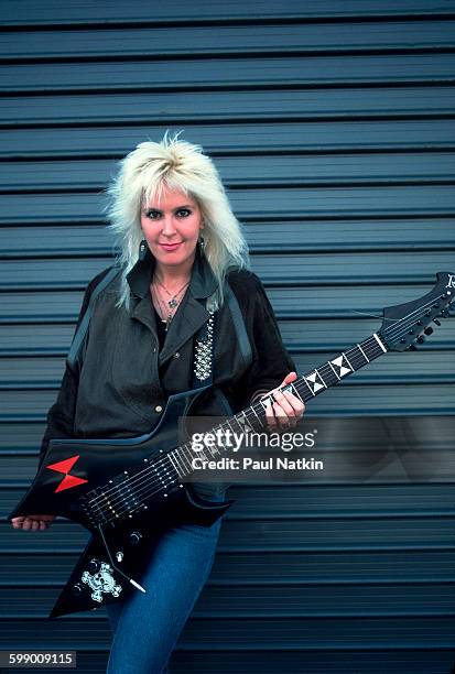 Portrait of American Rock musician Lita Ford as she poses outdoors with guitar, Los Angeles, California, March 18, 1985.