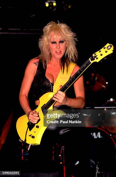 American Rock musician Lita Ford plays guitar as she performs onstage at the Aragon Ballroom, Chicago, Illinois, June 11, 1988.