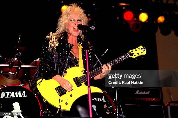 American Rock musician Lita Ford plays guitar as she performs onstage at the Aragon Ballroom, Chicago, Illinois, June 11, 1988.