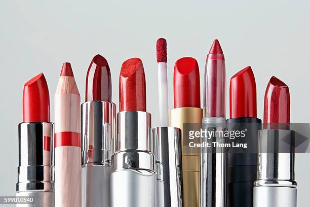 various red lipsticks lined upin a row - rossetto foto e immagini stock