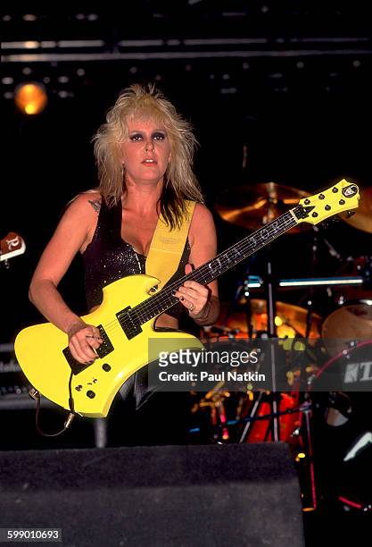 American Rock musician Lita Ford plays guitar as she performs onstage at the Aragon Ballroom, Chicago, Illinois, June 11, 1988.