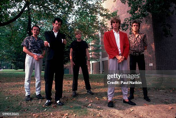 Portrait of British New Wave group the Fixx as they pose outdoors at Penn State University, State College, Pennsylvania, September 23, 1984. Pictured...