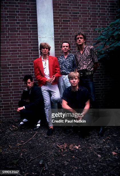 Portrait of British New Wave group the Fixx as they pose outdoors at Penn State University, State College, Pennsylvania, September 23, 1984. Pictured...