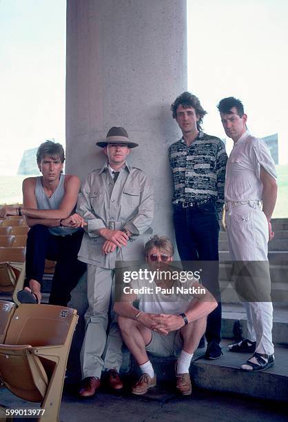 Portrait of British New Wave group the Fixx as they pose outdoors at the Poplar Creek Music Theater, Hoffman Estates, Illinois, July 5, 1986....