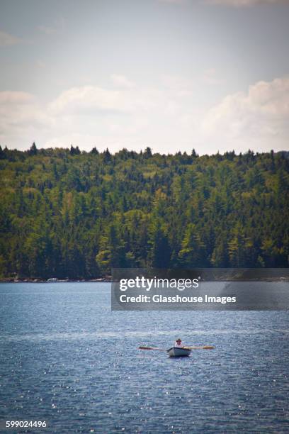 man in rowboat on lake - oquossoc - fotografias e filmes do acervo