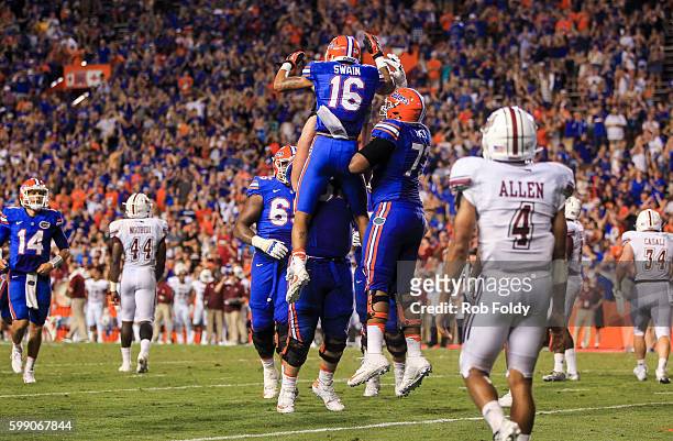 Freddie Swain of the Florida Gators celebrates with teammates after scoring a 2-point conversion during the second half of the game against the...