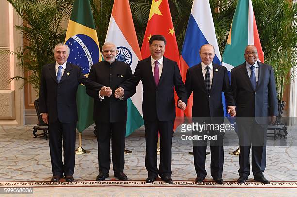 Chinese President Xi Jinping takes a group photo with Indian Prime Minister Narendra Modi , Brazil's President Michel Temer ,Russian President...