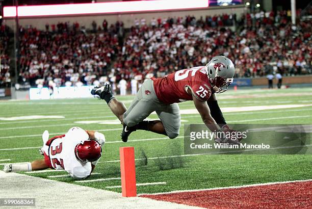Jamal Morrow of the Washington State Cougars attempts to score a touchdown in the second half against the Eastern Washington Eagles at Martin Stadium...