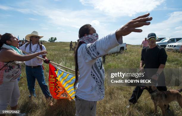 Native American protestors holds up his arms as he and other protestors are threatened by private security guards and guard dogs, at a work site for...