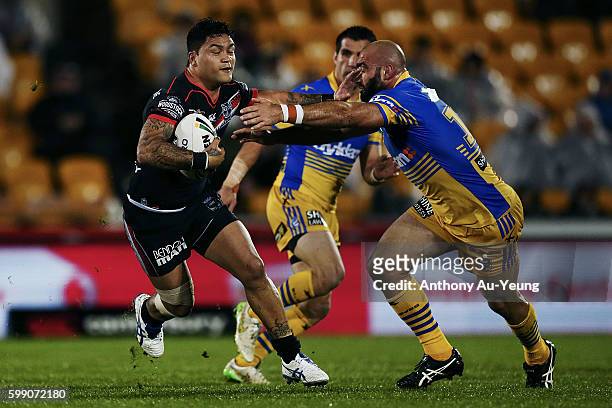 Issac Luke of the Warriors fends against Tim Mannah of the Eels during the round 26 NRL match between the New Zealand Warriors and the Parramatta...