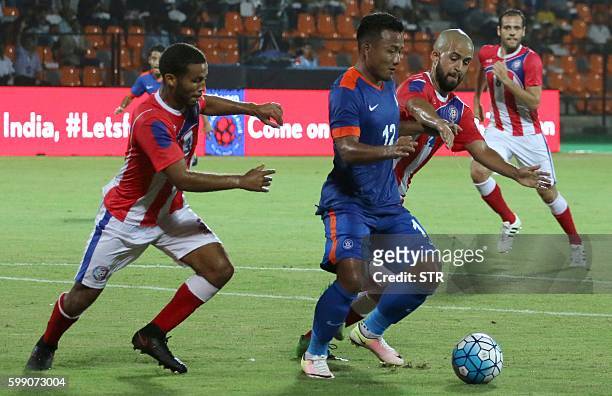 Jeje Lalpekhlua of India vies for the ball with defenders from Puerto Rico during a friendly football match between India and Puerto Rico in Mumbai...