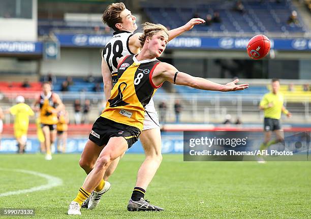 Matthew La Fontaine of the Dandenong Stingrays and Jy Lane of the Murray Bushrangers compete for the ball during the TAC Cup Qualifying Final match...