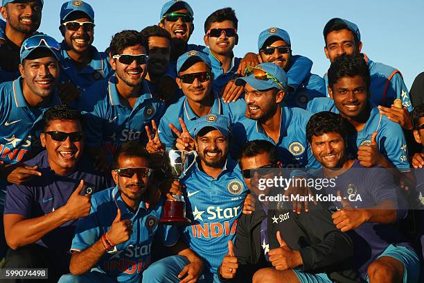 India A pose with the trophy as they celebrate victory during the Cricket Australia via Getty Images Winter Series Final match between India A and...