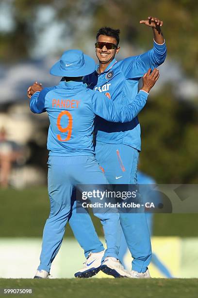 Manish Pandey of India congratulates Axar Patel of India A after he took the wicket of Peter Handscomb of Australia during the Cricket Australia via...