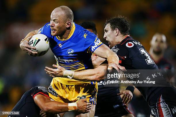 Beau Scott of the Eels charges against Ryan Hoffman of the Warriors during the round 26 NRL match between the New Zealand Warriors and the Parramatta...