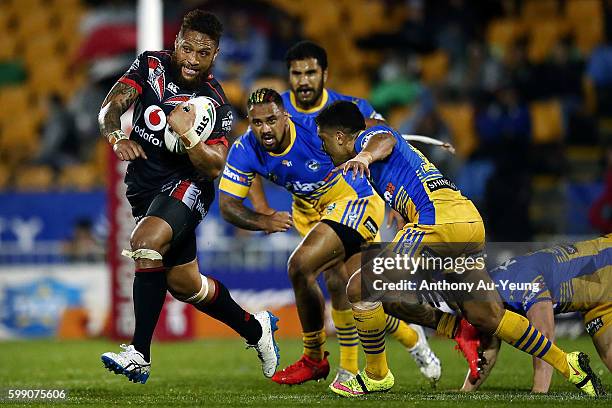 Manu Vatuvei of the Warriors makes a break against Ken Edwards of the Eels during the round 26 NRL match between the New Zealand Warriors and the...