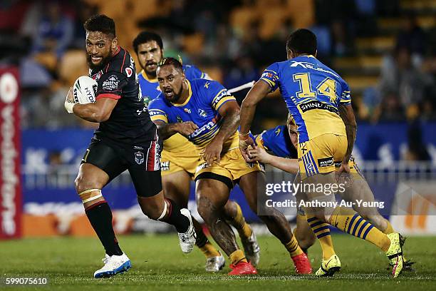 Manu Vatuvei of the Warriors makes a break against Ken Edwards of the Eels during the round 26 NRL match between the New Zealand Warriors and the...