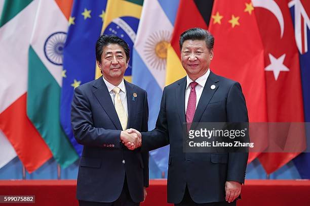Chinese President Xi Jinping shakes hands with Japanese Prime Minister Shinzo Abe to the G20 Summit on September 4, 2016 in Hangzhou, China. World...