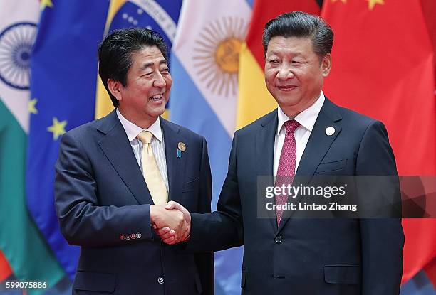 Chinese President Xi Jinping shakes hands with Japanese Prime Minister Shinzo Abe to the G20 Summit on September 4, 2016 in Hangzhou, China. World...