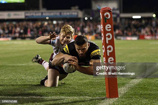 Joshua Mansour of the Panthers scores a try during the round 26 NRL match between the Penrith Panthers and the Manly Sea Eagles at Pepper Stadium on...