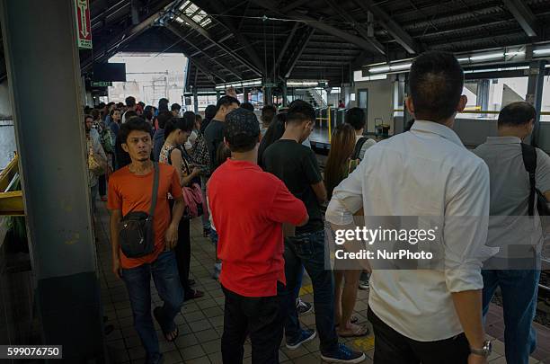 In this photo dated August 9 Filipinos wait for a northbound Light Rail Transit train at the EDSA station in Metropolitan Manila, Philippines....